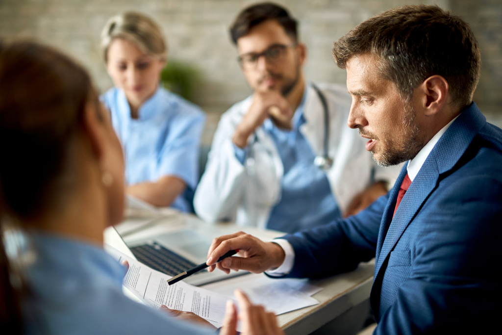 Key Points to Consider for Selling Robust Healthcare Integrations Effectively 5 A lawyer and doctors discussing compliance regulations in healthcare