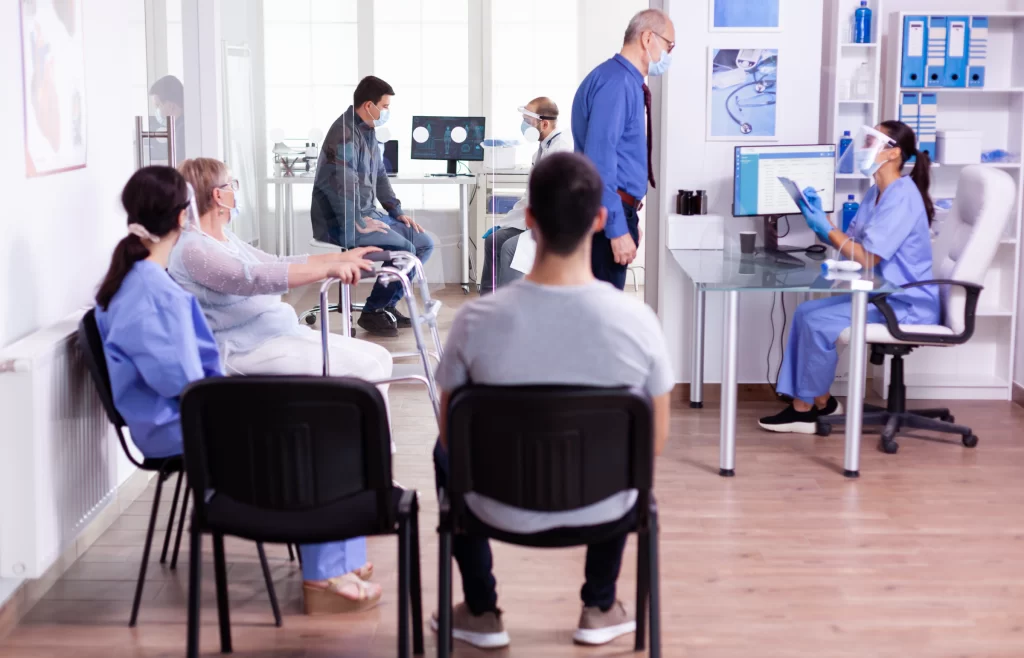 Navigating the Core Hurdles: Technical, Ethical, and Trust Challenges of AI in Healthcare 5 Physicians interacting with patients in a clinical setting